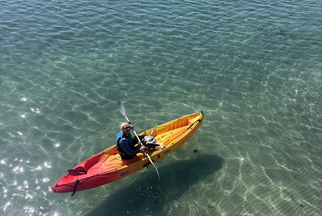Group of kayakers enjoying paddling along Inishmore coastline